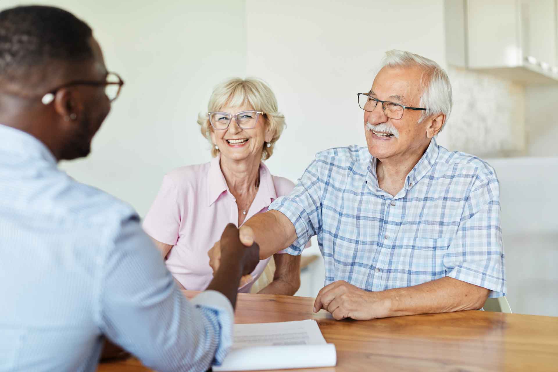 retired couple talking to financial advisor