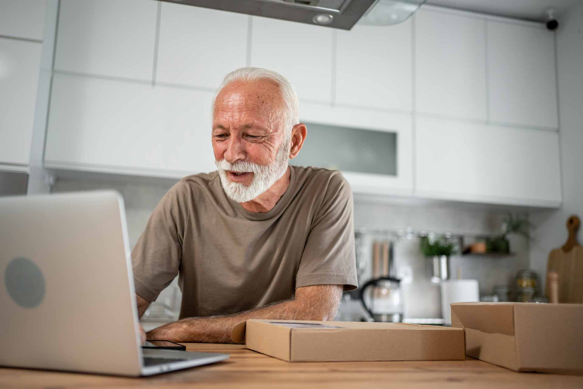 Senior entrepreneur running small business from home kitchen